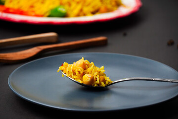Chana Pulao. Rice in Spoon. White Chickpeas Basmati Rice. Chana Biryani. Delicious Pakistani and Indian rice Cuisine.