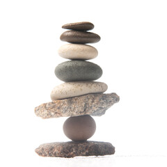 pyramid of stacked stones on a white background. stabilization and balance in life