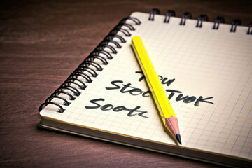 A pencil and a notebook with a postit note stuck on it that says Small steps towards success start with good practice now