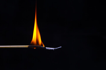 Burning wood match on a dark background close-up. burning tree fire