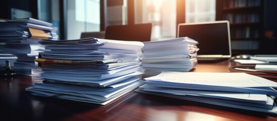 A collection of report papers for business purposes, such as annual reports and files for business and financial concepts, is placed on a desk.
