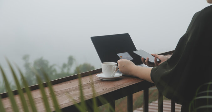 online payment, young woman holding credit card and touching on smartphone screen, copy space