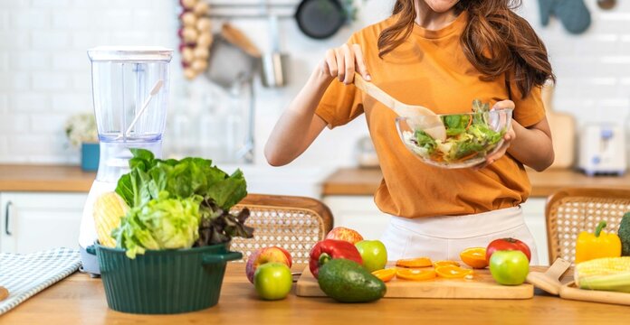 Portrait Of Beauty Body Slim Healthy Asian Woman Eating Vegan Food Healthy With Fresh Vegetable Salad In Kitchen At Home.diet, Vegetarian, Fruit, Wellness, Health, Green Food.Fitness And Healthy Food