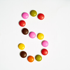 Letters written with  multi colored chocolate candy 