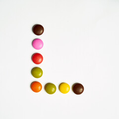 Letters written with  multi colored chocolate candy 