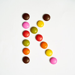 Letters written with  multi colored chocolate candy 