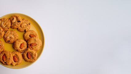 Homemade almond cookies on a plate on white background
