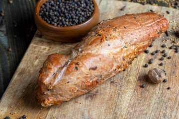 Cooked pork with spices on a board