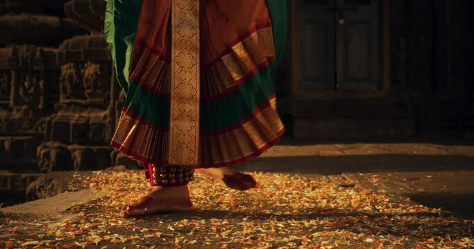 Close-Up Shot of the Legs of an Indian Female Dancer Doing a Folkloric Dance. Slow Motion Shot of Girl in Traditional Sari Showcasing Swiftly the Art of Bharatanatyam Choreography