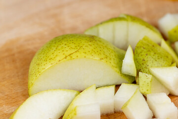 sliced green pear on a wooden board close-up