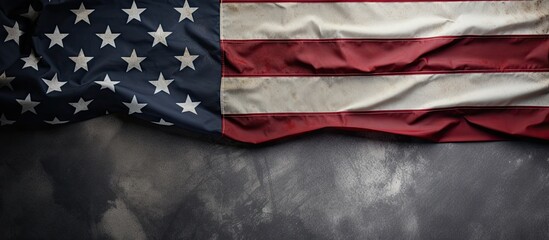 A view from above showing the United States flag, representing Memorial Day or Independence Day. The flag is displayed on a concrete board background, with space for text.