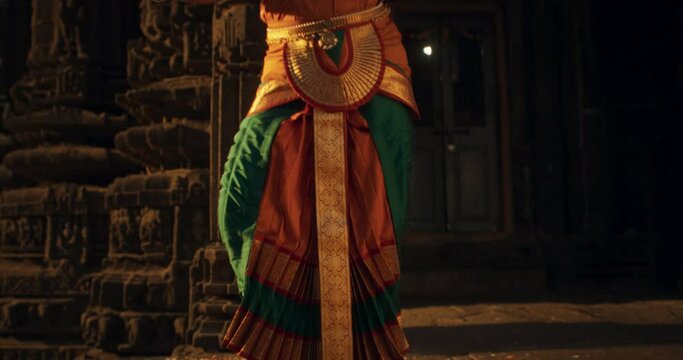  Tracking Shot Portrait of Lively Indian Woman Wearing Traditional Clothes, Dancing Bharatanatyam with Expressive Face and Swift Moves. Enjoy South Asian Folk Dance in an Old Stone Temple
