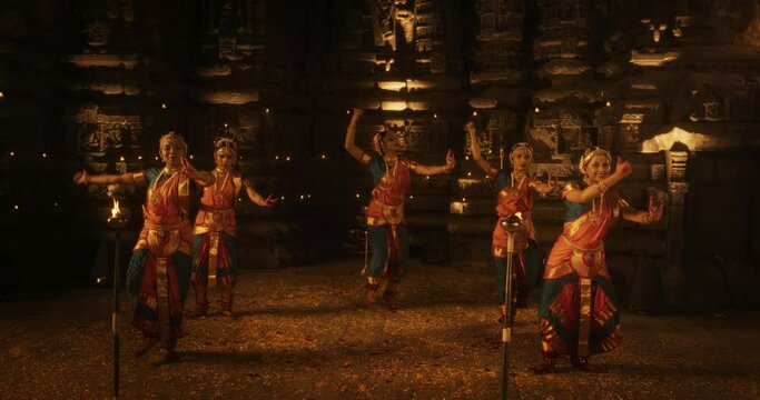 Slow Motion Portrait of Energetic Group of Indian Women Joyfully Dancing Traditional Folk Dance Inside an Empty Historical Temple. Colorful and Captivating South Asian Cultural Celebration