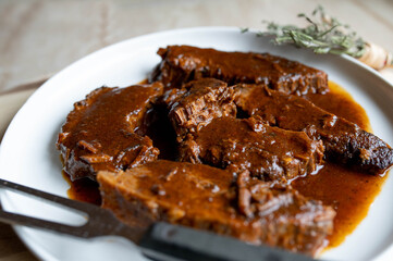 Fresh cooked roast with brown sauce on a plate