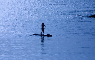 Man in the water just before sunset, blue waves, power of nature 