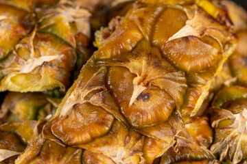 Fototapeta premium green-yellow peel of ripe pineapple close-up