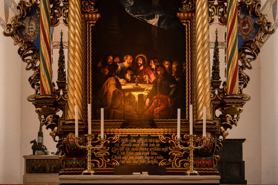 Ornated wooden altarpiece with a painting of the Last Supper
