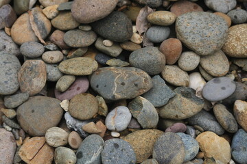 Pebbles on the beach, close up of stones on the beach