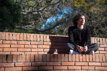Fototapeta premium colorful winter clothing fashion editorial held in Montevideo, Uruguay, in a public park in the middle of nature on a sunny day.