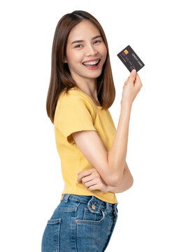Cheerful beautiful Asian woman holding mockup credit card on background.