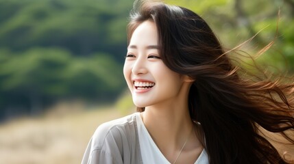 Naklejka premium Close-up portrait of a beautiful Asian model laughing and smiling with clean teeth. Used for dental advertising isolated on white background
