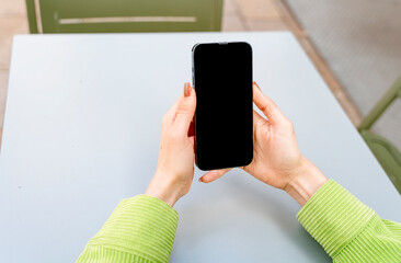 woman having coffee at the street cafe outside, talking on the phone and having fun time. lifestyle concept