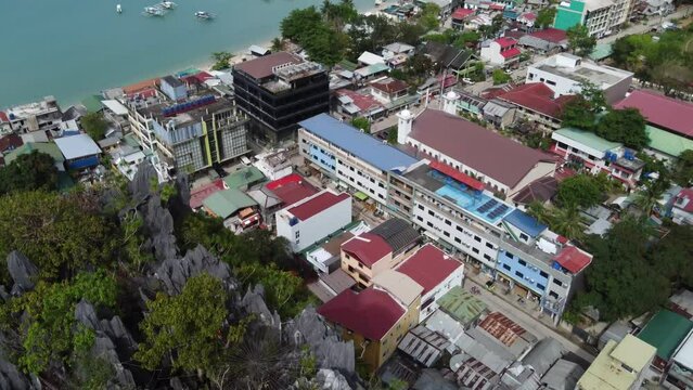 Aerial view of Tour Boats anchored at the bay against the beach of El Nido town seen from Canopy Walk, also called taraw Cliff, Philippines