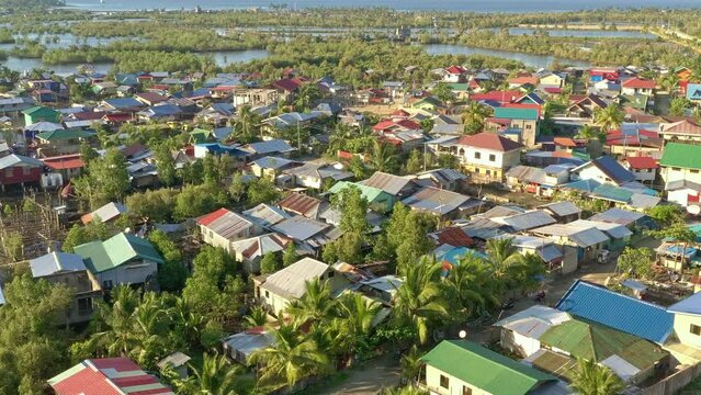 Low cinematic aerial over the area know a Settlers, a Squatters slum near Surigao City Philippines. New 04-08-23