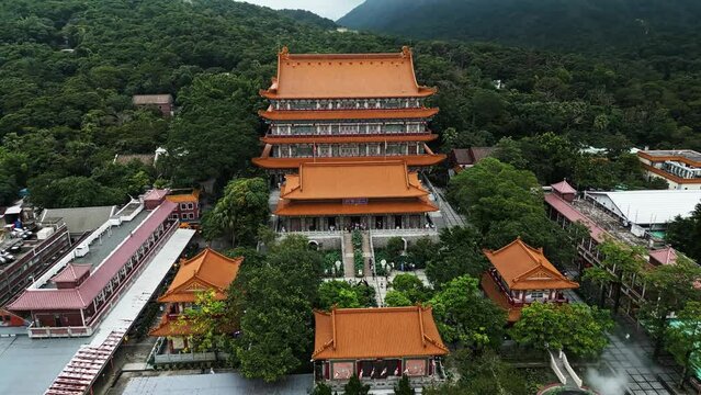 Aerial around the Po Lin Monastery on Lantau Island, Hong Kong, China. Drone dolly forward and orbit shot