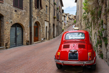 old nostalgia red car in the italy street, tuscany