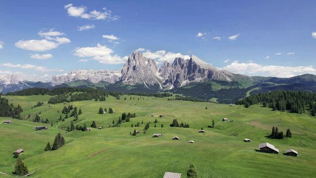 Aerial view of picturesque alpine pasture with mountain huts, Dolomites