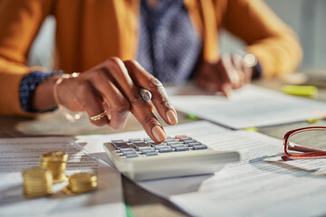 Black woman hand calculating taxes - 632103149