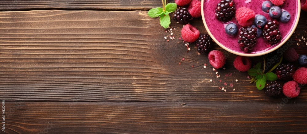Aufkleber A view from the top with copy space showing a raspberry smoothie and a bowl of berries on a wooden table.