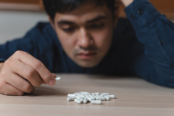 the person using drug overdoses lying on the table. close up on pills