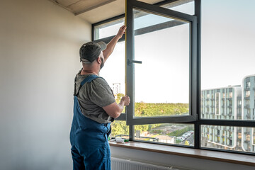 Construction workers installing new window in apartement