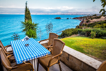 Dinning table on the rocky shore over the sea