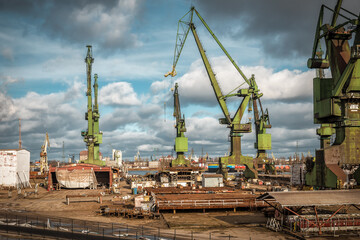 Fototapeta na wymiar Large historical port cranes in the industrial part of the city