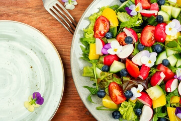 Tasty summer salad with edible flowers