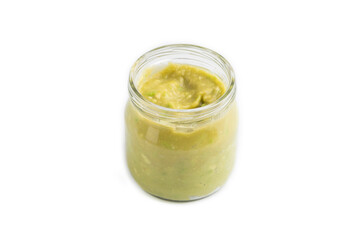 Baby puree with vegetable mix, broccoli, avocado in glass jar isolated on white, side view