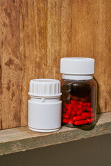 a white plastic painkiller bottle on a shelf
