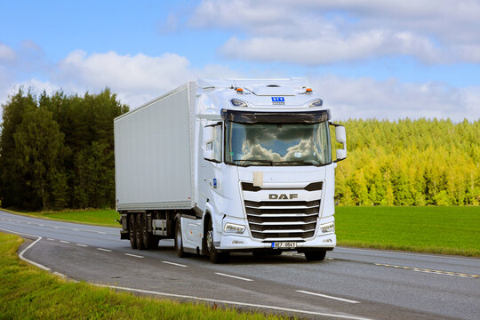New White DAF XG 480 Truck Semi Trailer Transports Load along Highway on a Day of Summer.