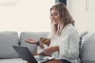 Portrait of young beautiful blonde girl talking with colleagues studying online in class room...