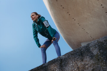 Tired female runner taking a rest after running hard up the stairs in city park. © Halfpoint