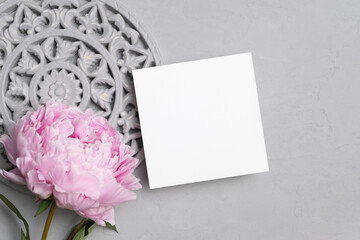 Square paper card mockup with flowers decor, blank card mock up with copy space