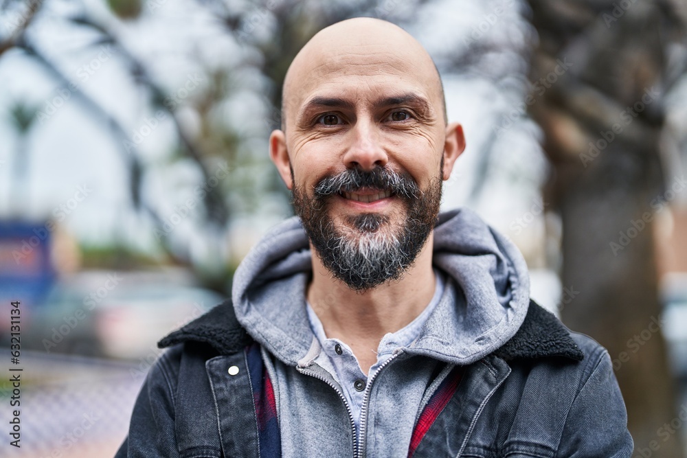 Canvas Prints Young bald man smiling confident standing at street