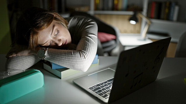 Young blonde woman student sleeping on the desk at library university