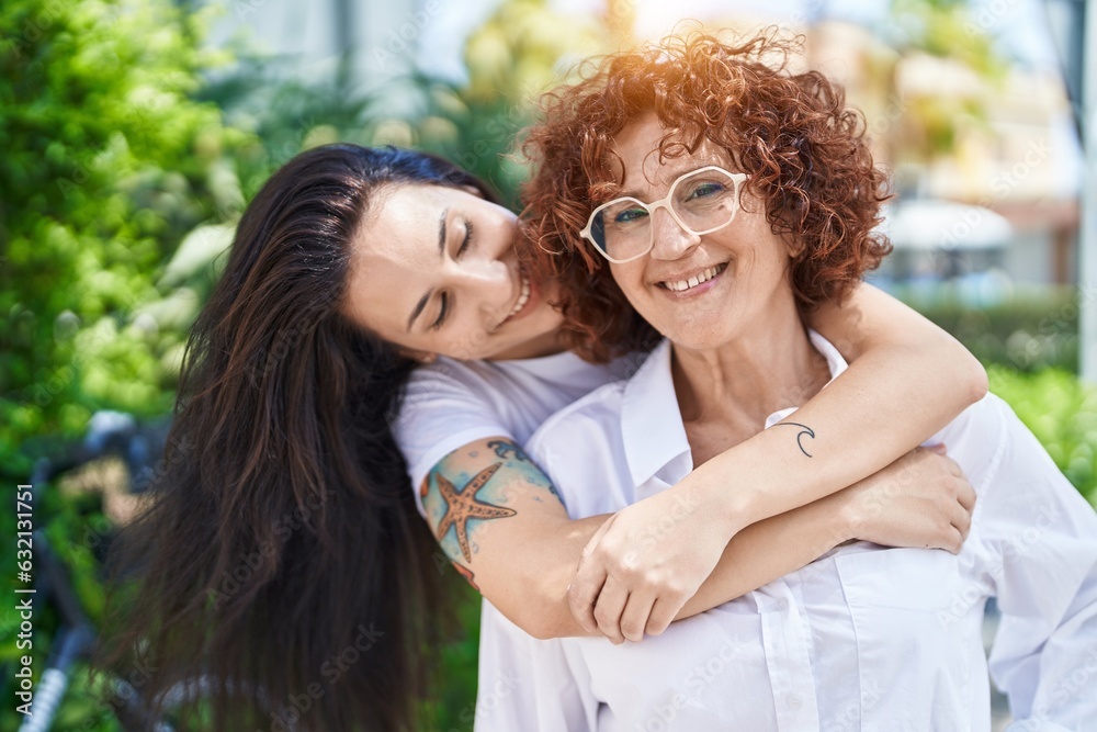 Poster two women mother and daughter hugging each other at park