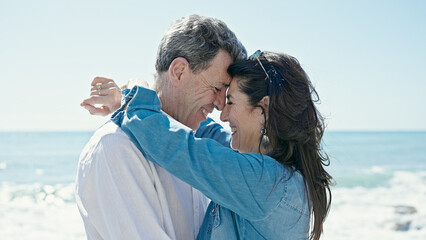 Senior man and woman couple smiling confident hugging each other at seaside © Krakenimages.com