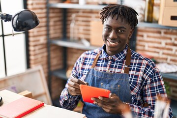 African american man artist drawing on touchpad at art studio