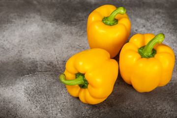 PAPRIKA.Fresh yellow bell pepper on black textural background. Bulgarian salad pepper .Fresh vegetables. Harvest. Vegan. close up